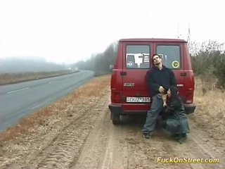 Lascivious strumpet sucks member on the road