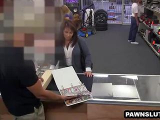 Brunette tries to sell some cards to the pawn shop